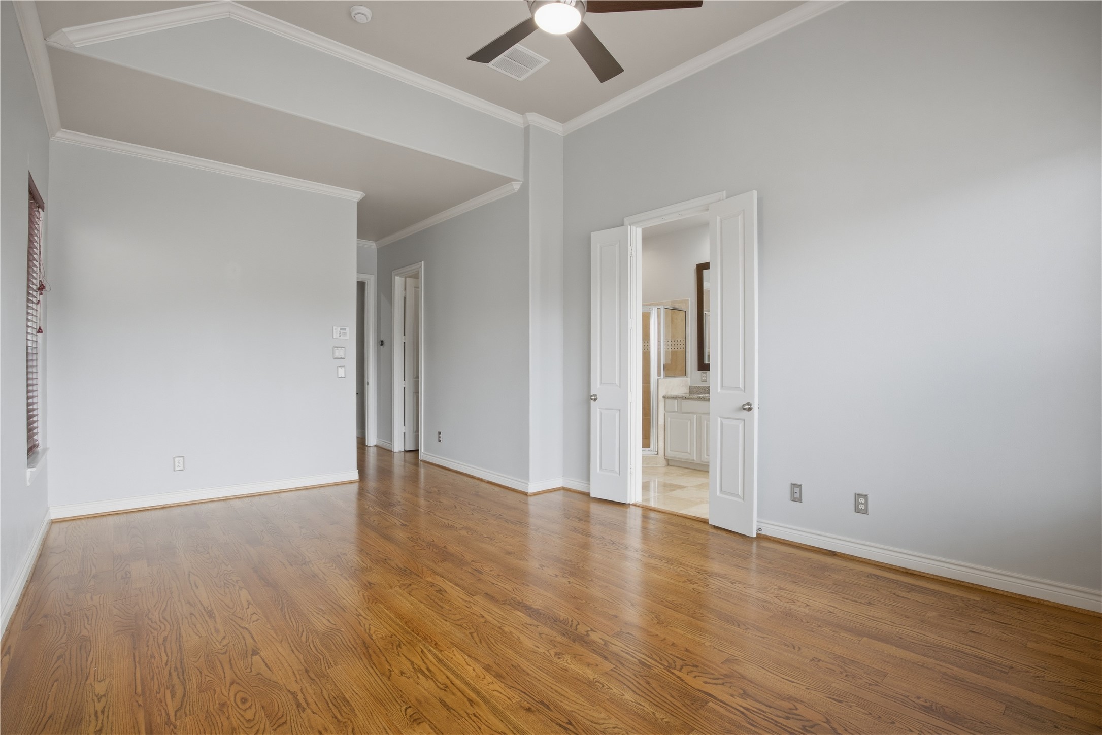5719 Darling Street Houston, TX 77007 - Photo 11 of 35 an empty room with wooden floor and a ceiling fan
