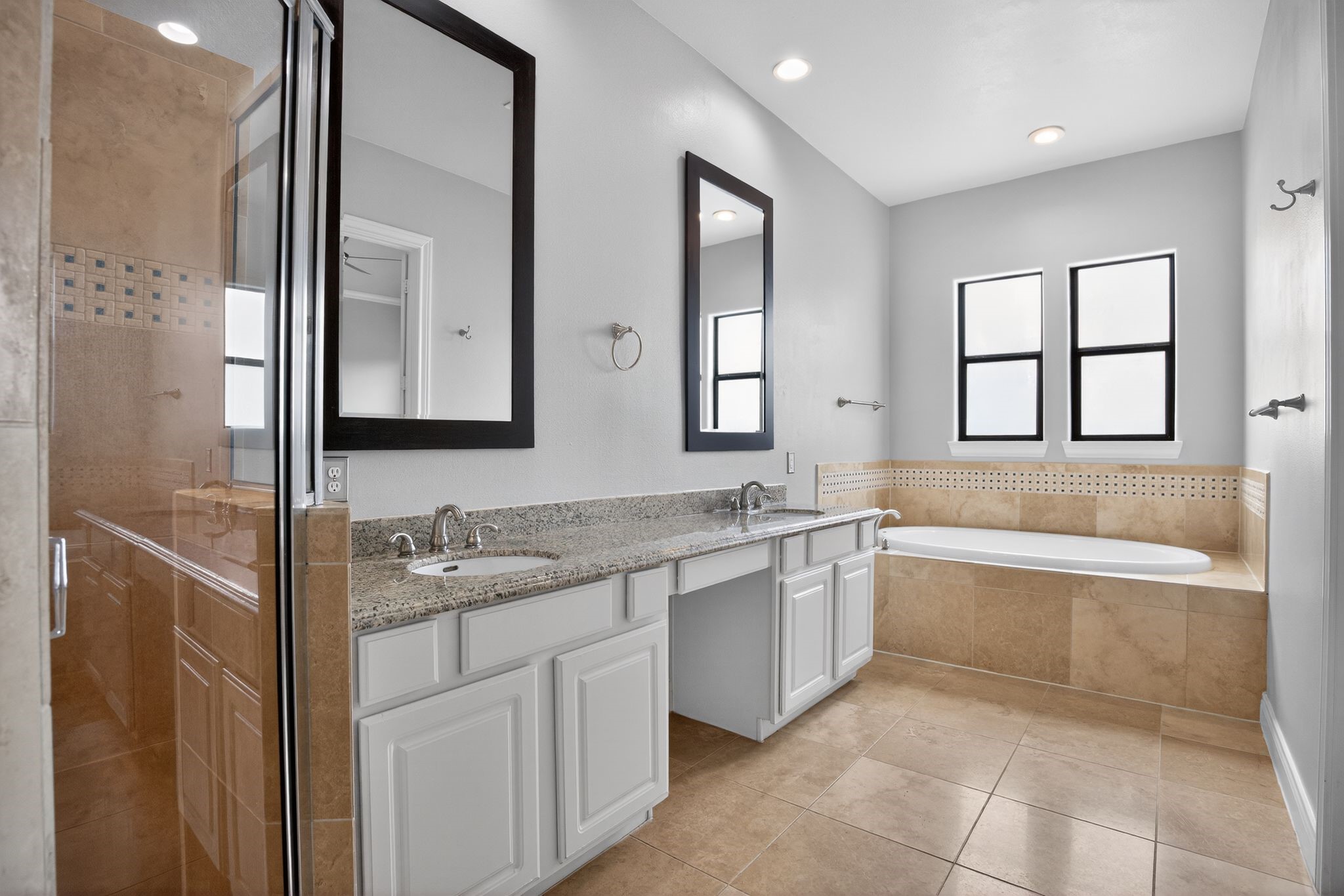 5719 Darling Street Houston, TX 77007 - Photo 13 of 35 a bathroom with a granite countertop sink and a bathtub