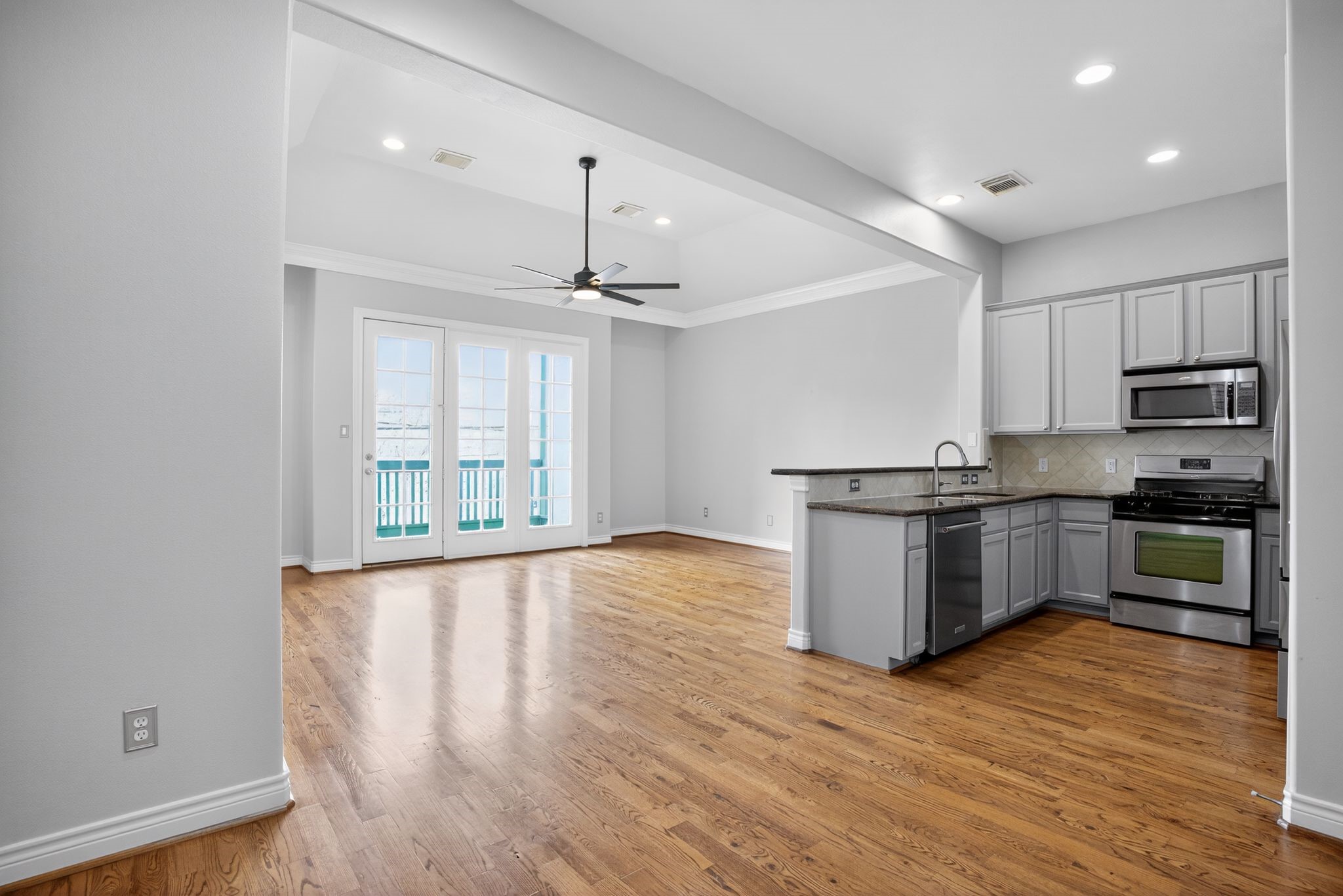 5719 Darling Street Houston, TX 77007 - Photo 14 of 35 a kitchen with stainless steel appliances granite countertop a stove a sink and a refrigerator