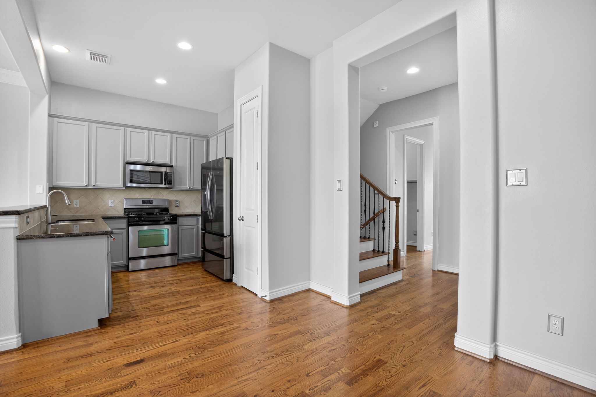 5719 Darling Street Houston, TX 77007 - Photo 15 of 35 a kitchen with stainless steel appliances granite countertop a refrigerator and a stove top oven