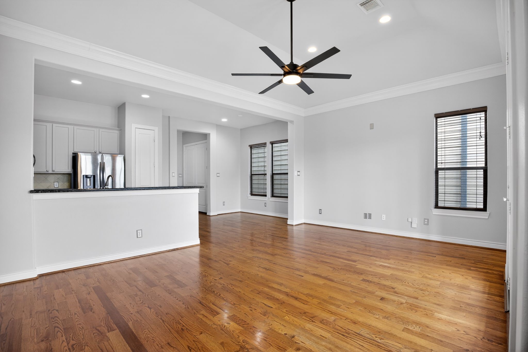 5719 Darling Street Houston, TX 77007 - Photo 19 of 35 a view of an empty room with wooden floor and a window