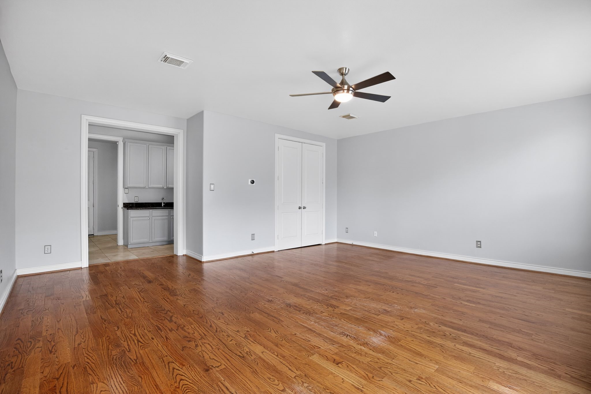 5719 Darling Street Houston, TX 77007 - Photo 6 of 35 a view of empty room with wooden floor and ceiling fan