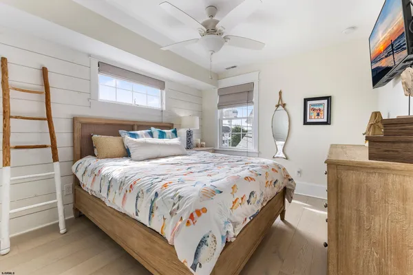 a bedroom with two beds and a window