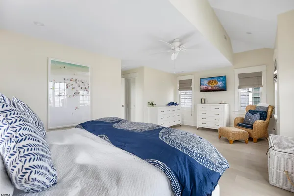 a bedroom with a large bed and a couch