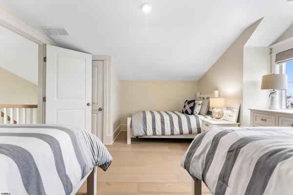 a bedroom with two beds and a couch