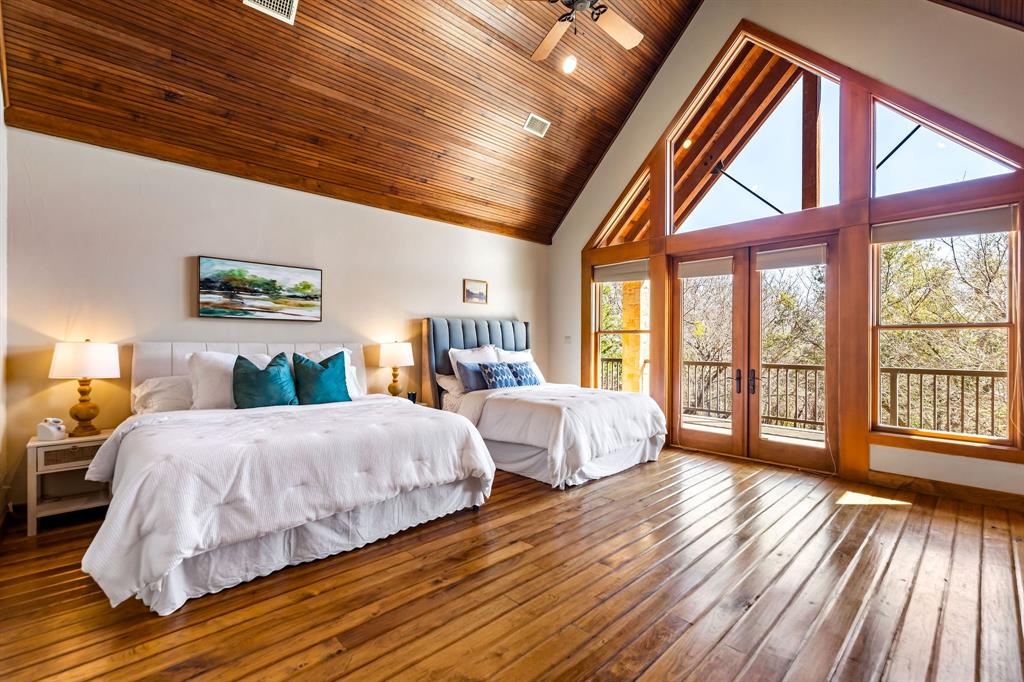 9930 Boat Club Road Fort Worth, TX 76179 - Photo 36 of 40 Hill Lodge’s bedroom 2 of 3 features soaring wood ceilings, custom built-ins, and large windows that fill the space with natural light.