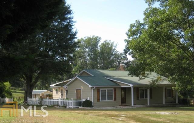 665 Pleasant Hill Road Martin, GA 30557 - Photo 1 of 1 a front view of a house with a yard balcony and large trees