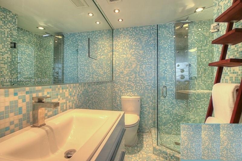 20 Island Avenue, Unit 209 Miami Beach, FL 33139 - Photo 3 of 12 a bathroom with a tub a sink and a shower