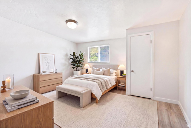 215 Carol Way Midvale, UT 84047 - Photo 17 of 30 Main level Bedroom featuring light wood finished floors and baseboards