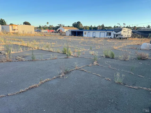 a kitchen with stainless steel appliances granite countertop a refrigerator and a stove