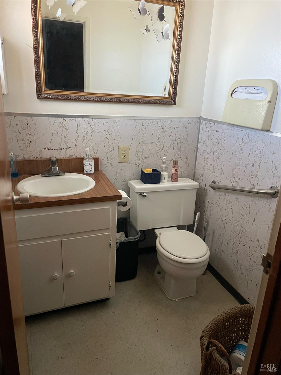 1487 Lemon Street Vallejo, CA 94590 - Photo 26 of 29 a bathroom with a toilet sink and mirror