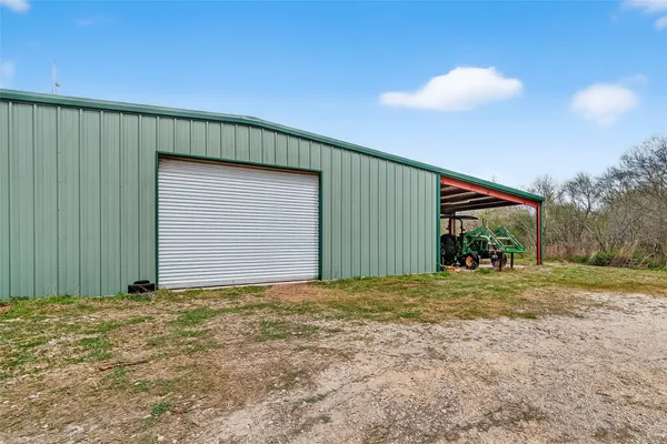 a view of a house with a yard and garage