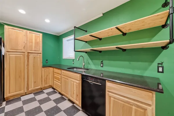 a kitchen that has a sink and a chair