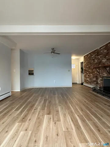a kitchen with stainless steel appliances granite countertop a sink window and cabinets