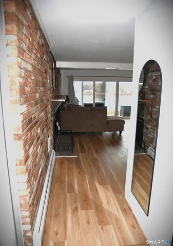 a view of a room with wooden floor and a window