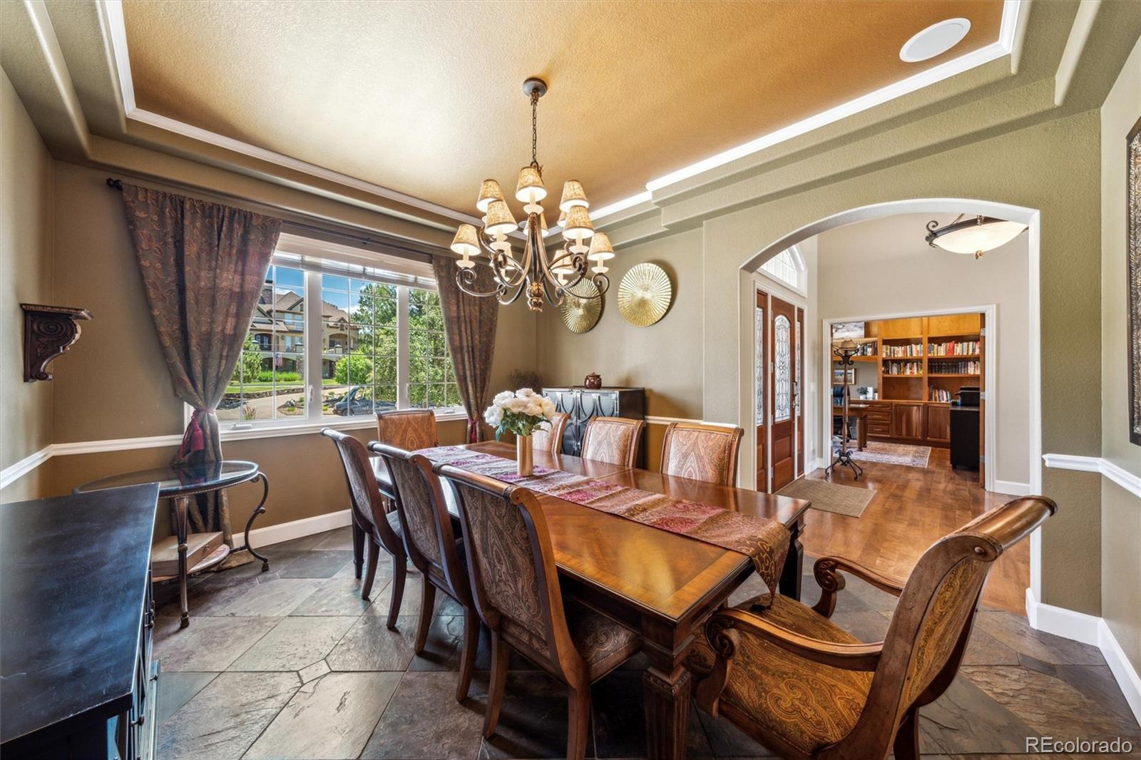 5159 Warbler Court Parker, CO 80134 - Photo 15 of 50 a dining room with furniture a chandelier and window