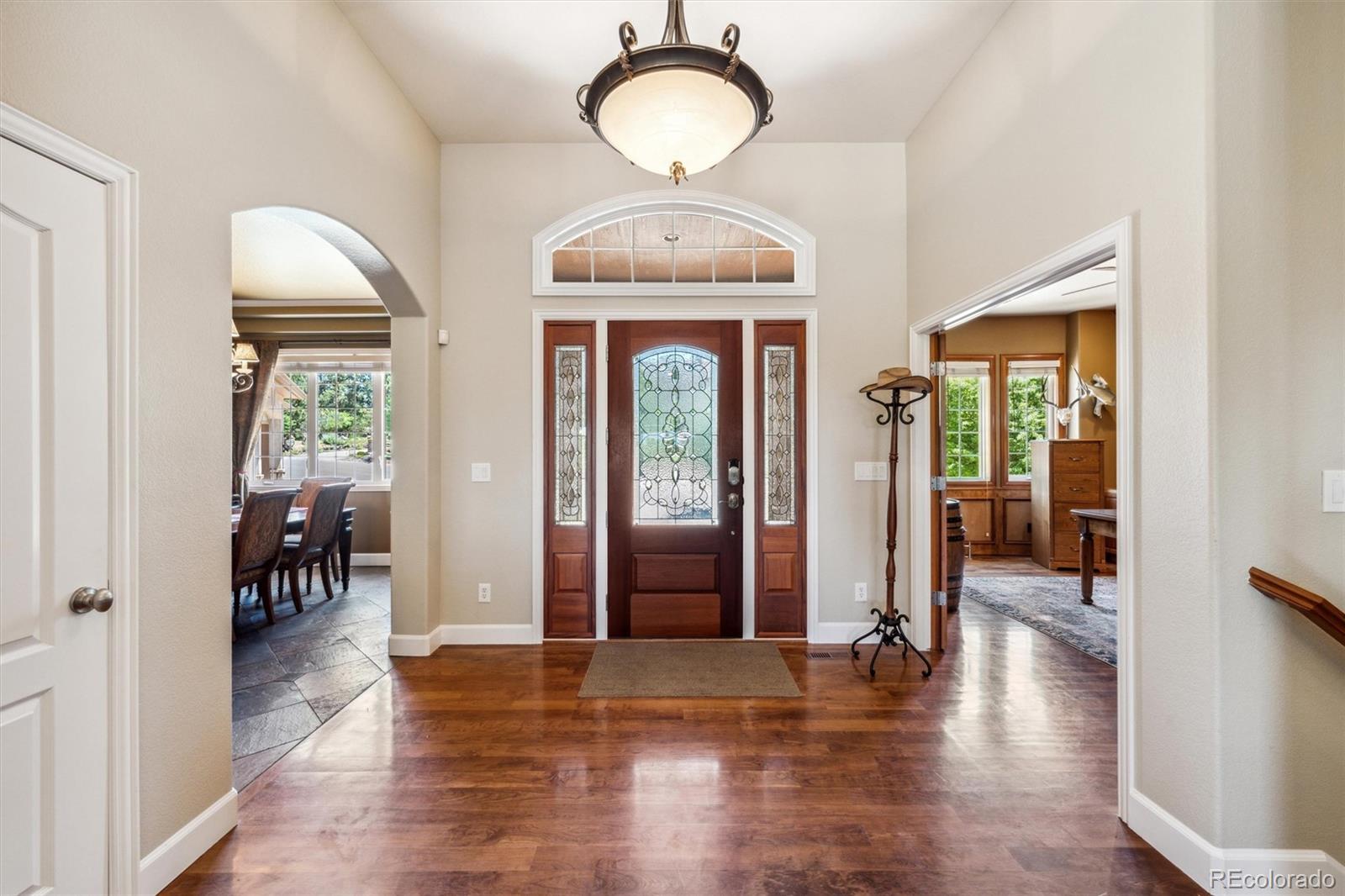 5159 Warbler Court Parker, CO 80134 - Photo 16 of 50 a view of a hallway with wooden floor windows and livingroom view