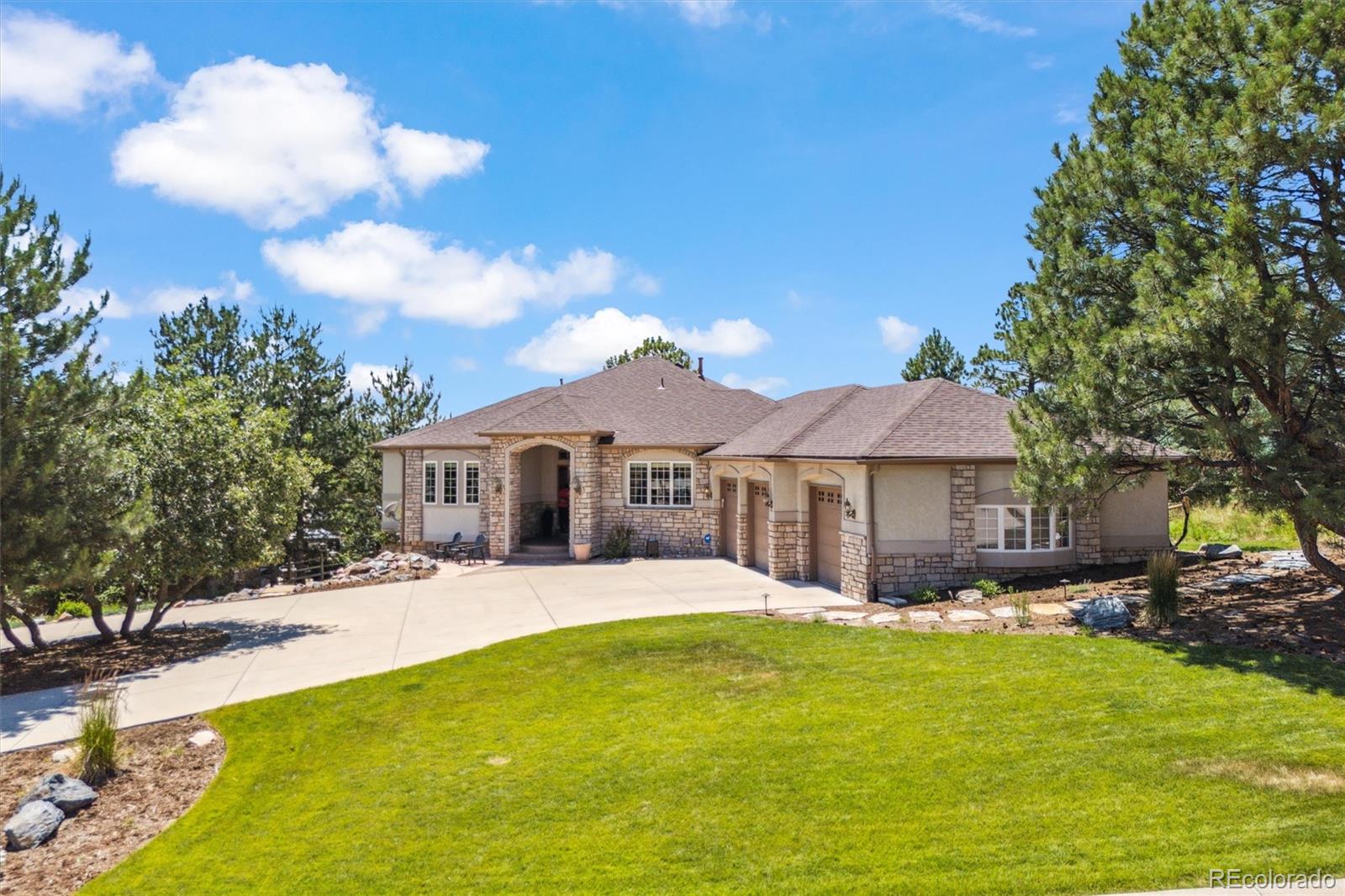 5159 Warbler Court Parker, CO 80134 - Photo 2 of 50 a front view of a house with a yard table and chairs
