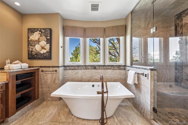 a bathroom with a bathtub and a window