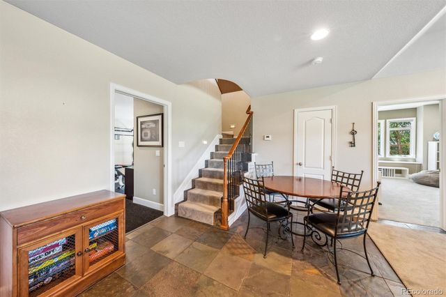 a dining room with furniture and wooden floor