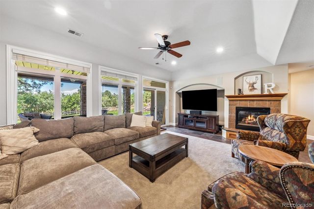 a living room with furniture fireplace and a flat screen tv