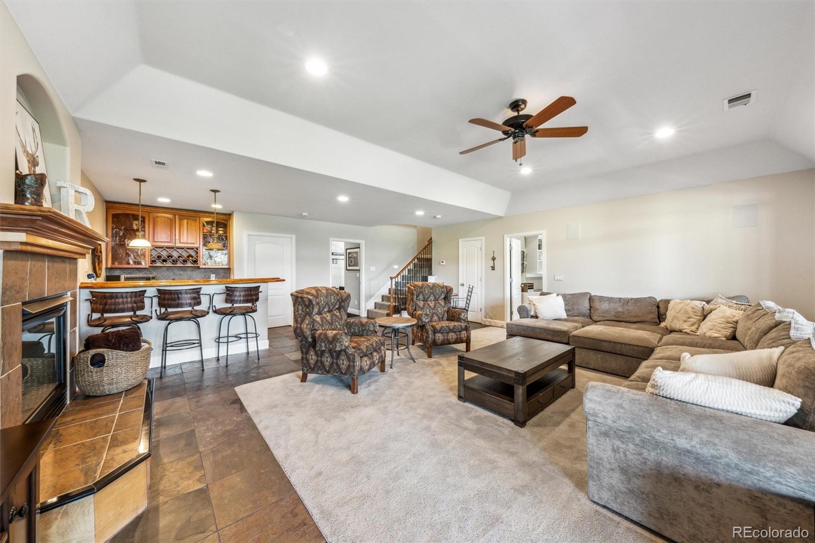 5159 Warbler Court Parker, CO 80134 - Photo 37 of 50 a living room with furniture kitchen view and a wooden floor