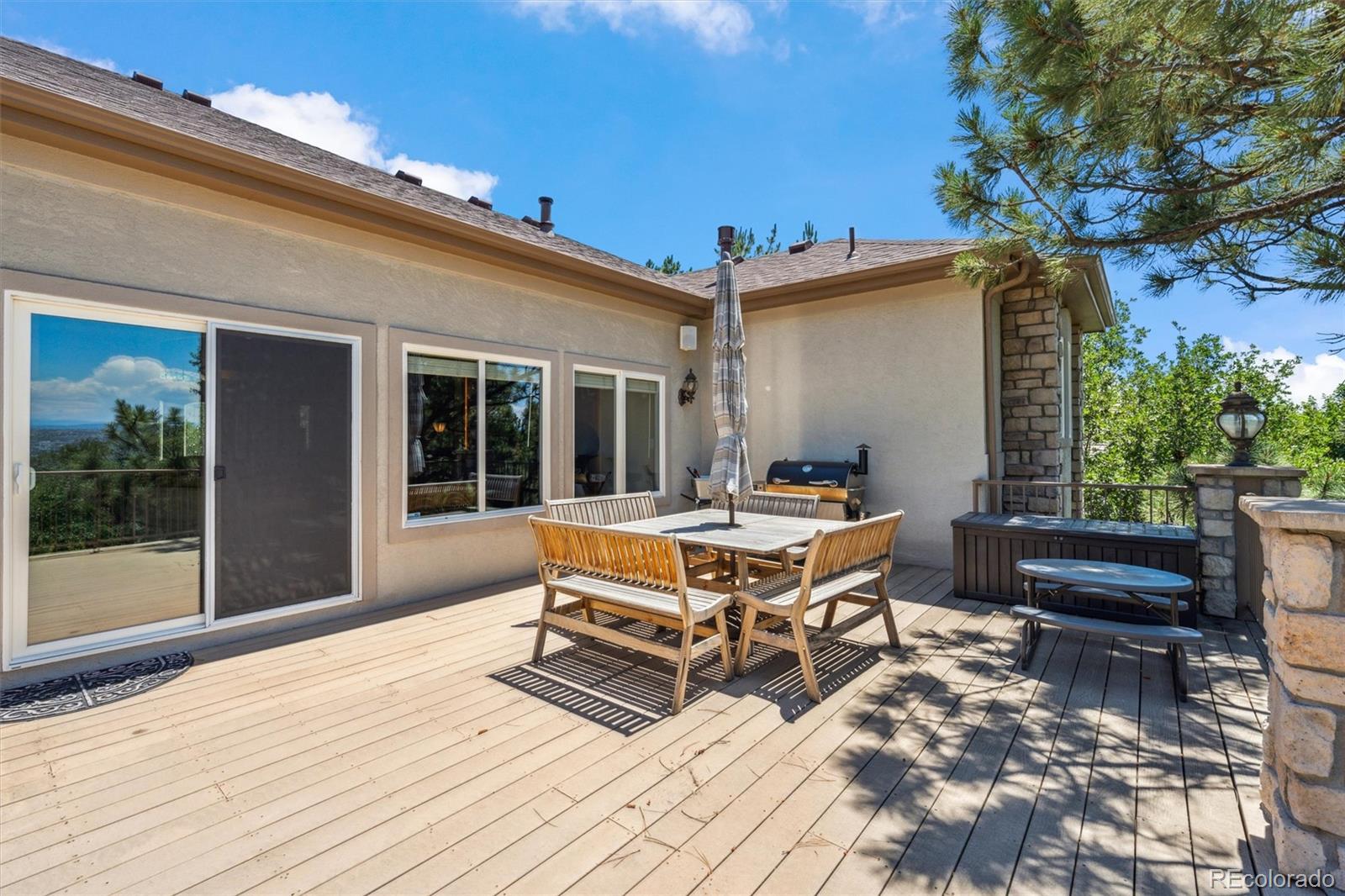 5159 Warbler Court Parker, CO 80134 - Photo 42 of 50 a roof deck with a table and chairs