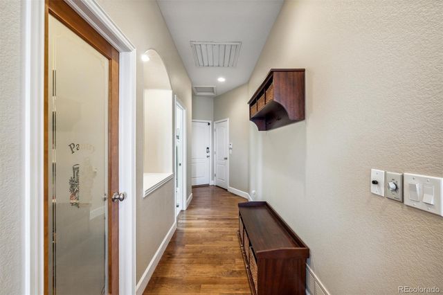 a hallway of a house with wooden floor