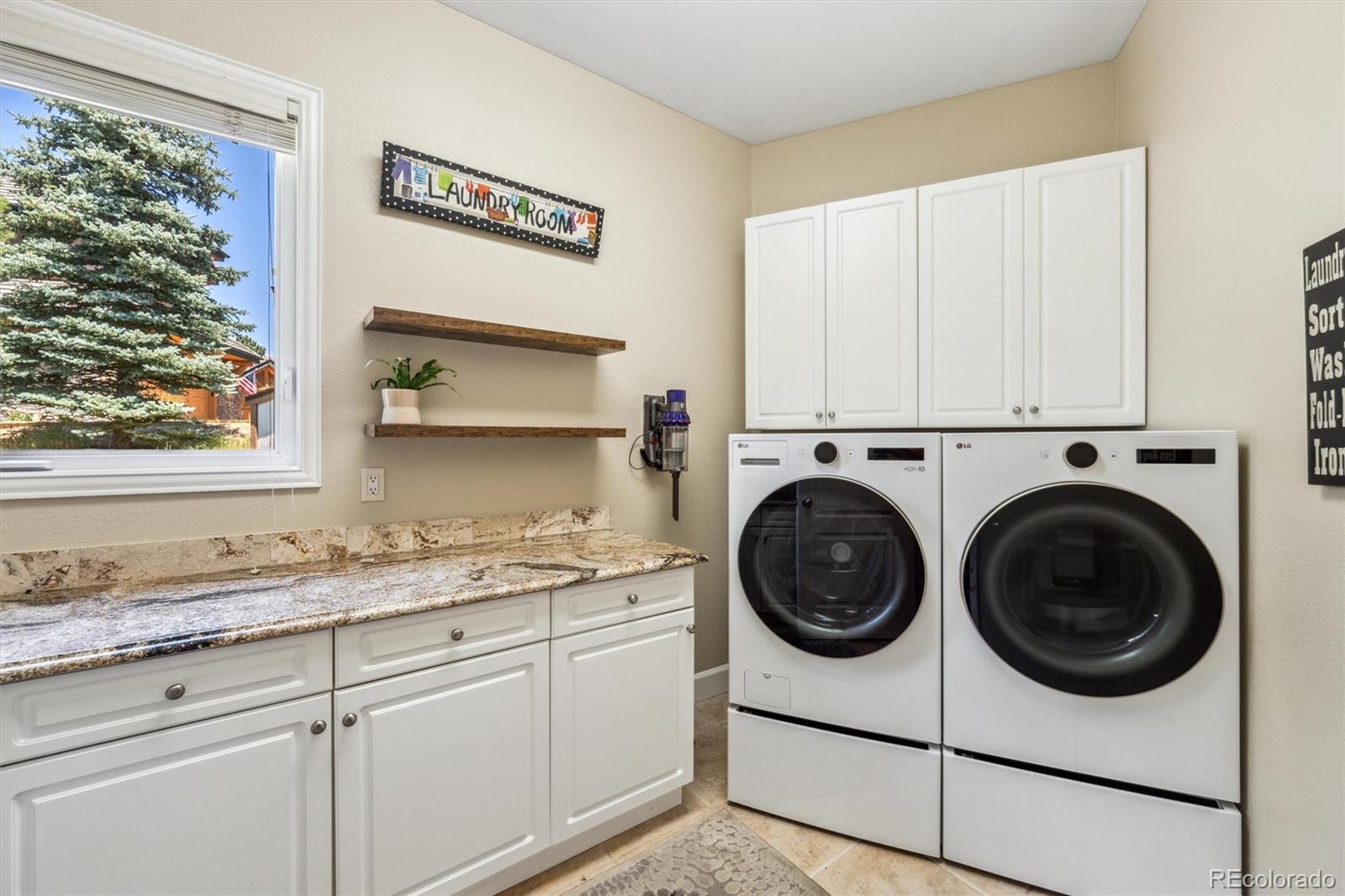 5159 Warbler Court Parker, CO 80134 - Photo 8 of 50 a utility room with sink dryer and washer