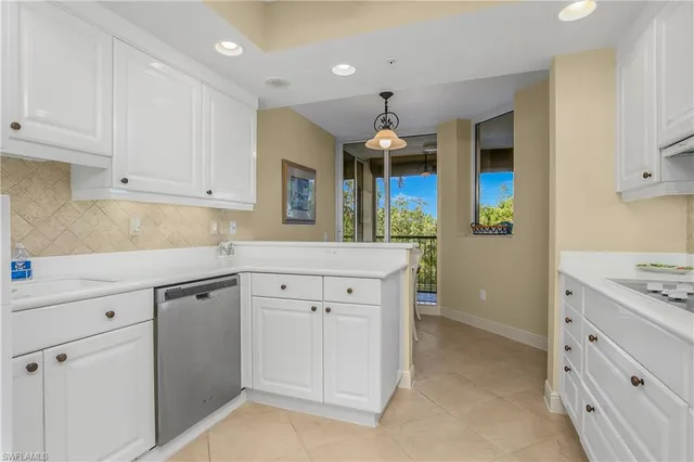 a kitchen with cabinets and window