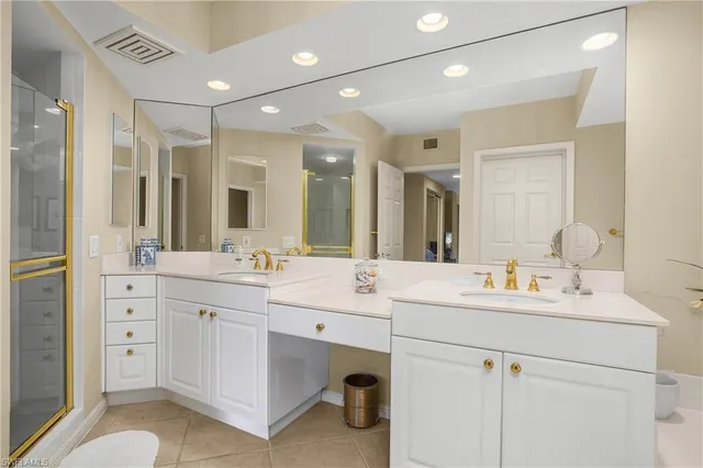 a bathroom with a double vanity sink mirror and double