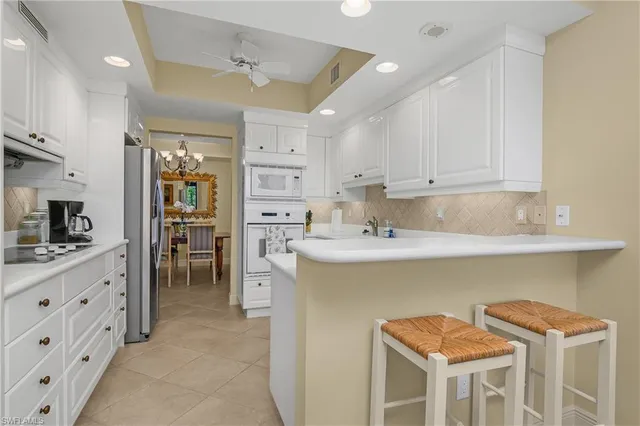 a kitchen with stainless steel appliances granite countertop a sink and a refrigerator