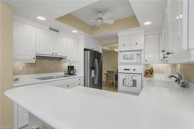 a kitchen with stainless steel appliances a refrigerator sink and cabinets