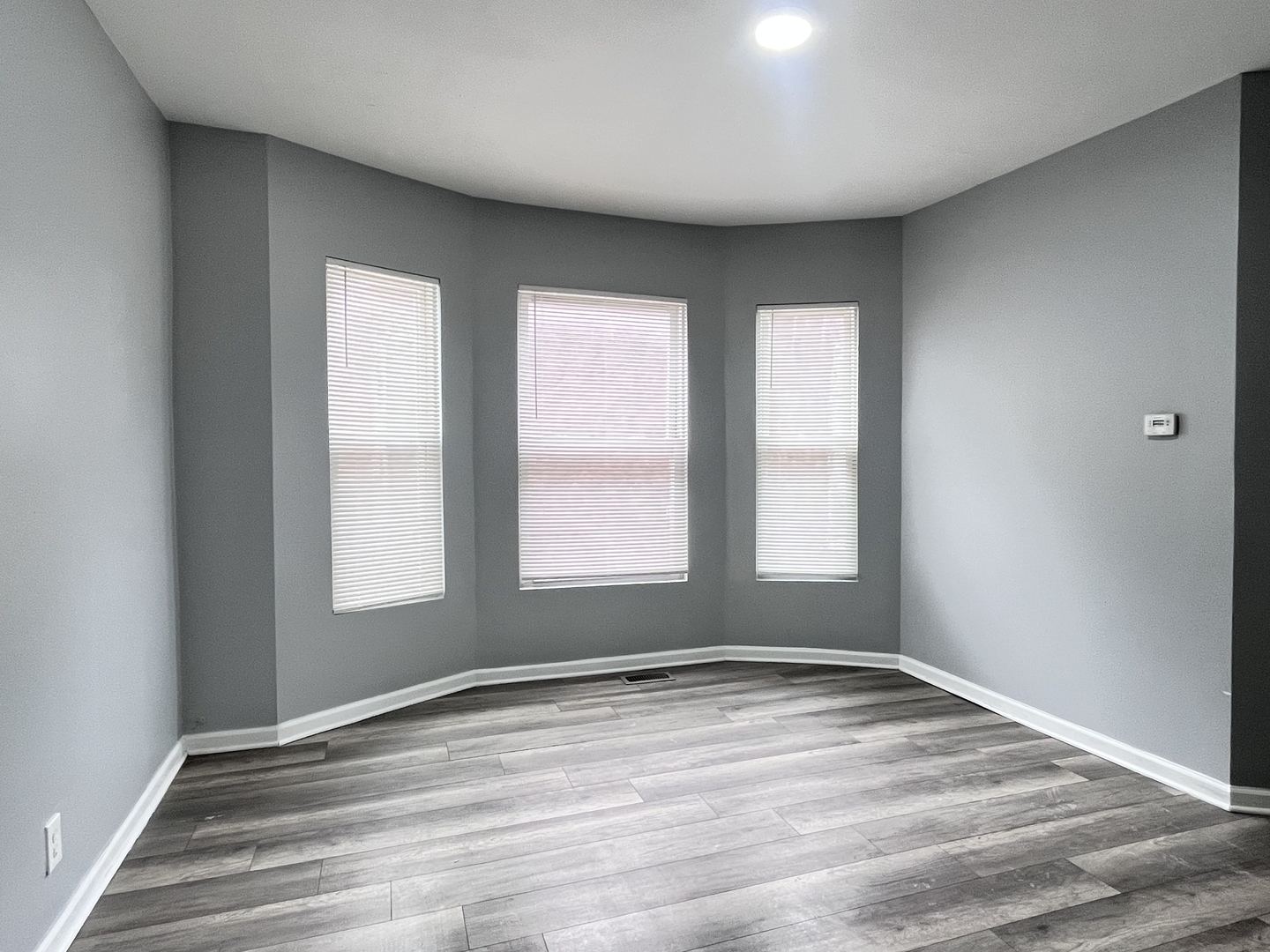 10739 South State Street Chicago, IL 60628 - Photo 12 of 14 a view of empty room with wooden floor and fan