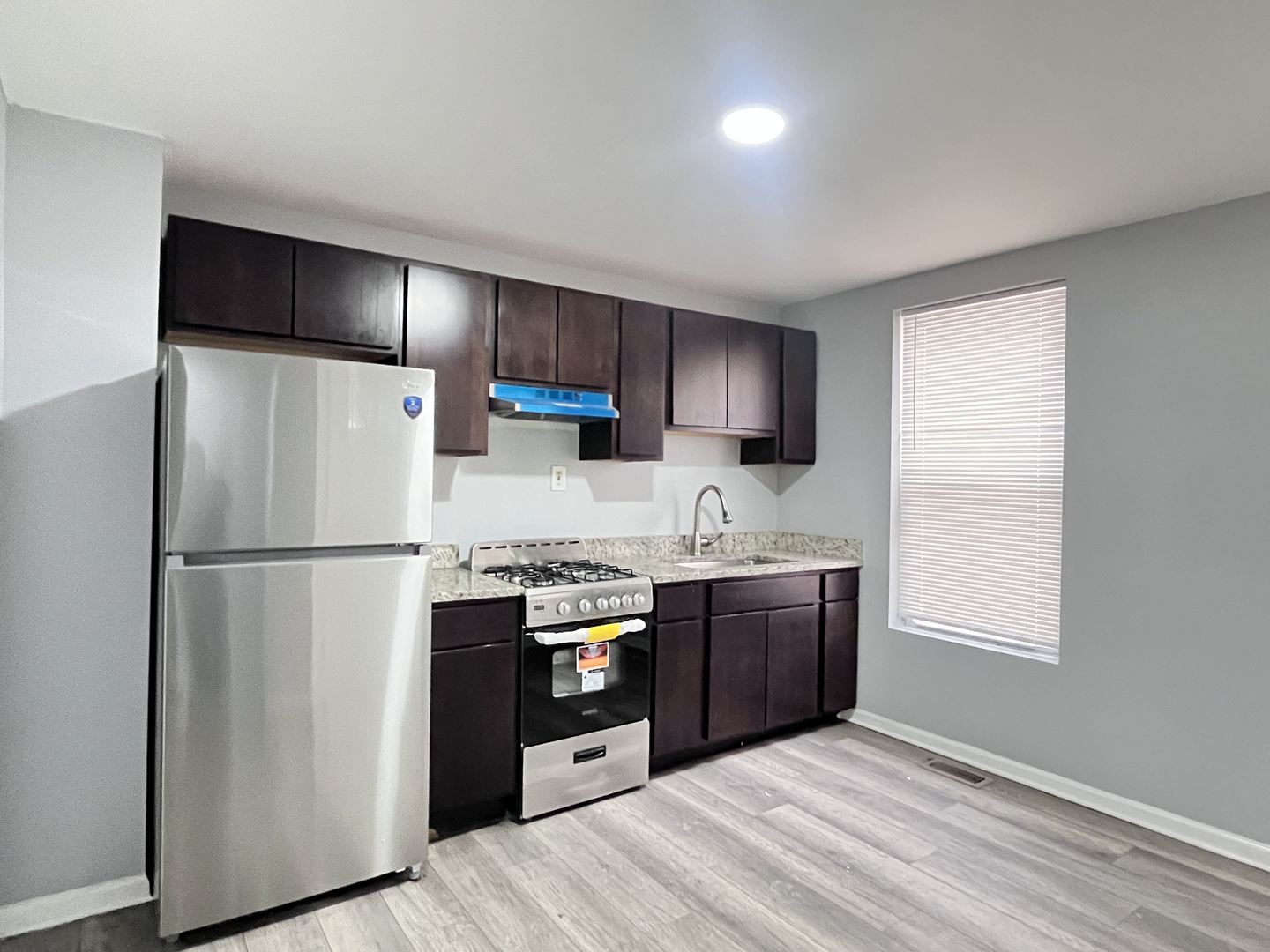 10739 South State Street Chicago, IL 60628 - Photo 2 of 14 a kitchen with stainless steel appliances granite countertop a refrigerator stove and sink