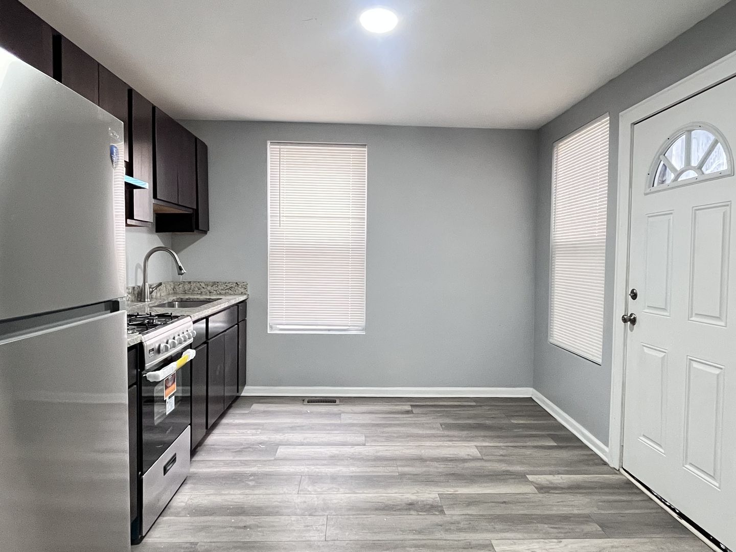 10739 South State Street Chicago, IL 60628 - Photo 3 of 14 a kitchen with granite countertop a stove and a sink