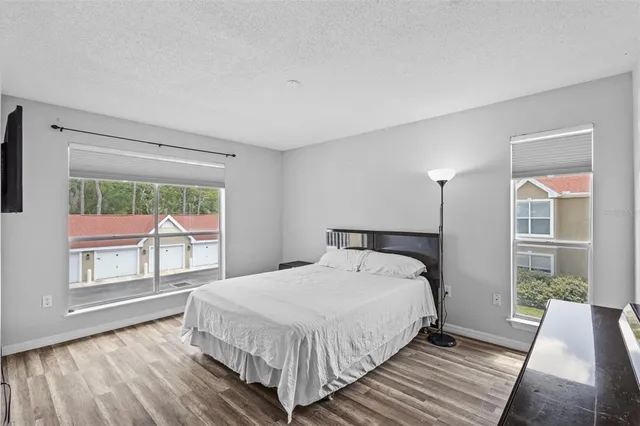 a large bed sitting in a bedroom next to a window