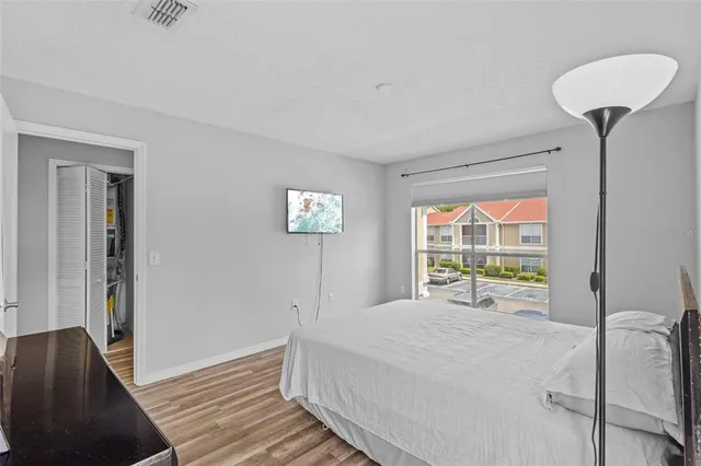 a bedroom with a bed and a chandelier