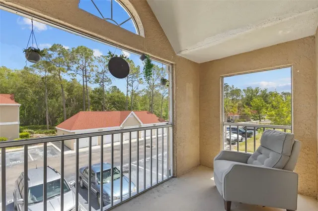 a balcony view with couches and wooden floor