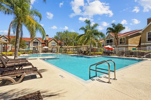 a swimming pool with outdoor seating yard and barbeque oven