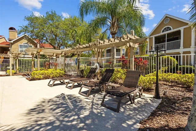 a view of a house with backyard porch and sitting area