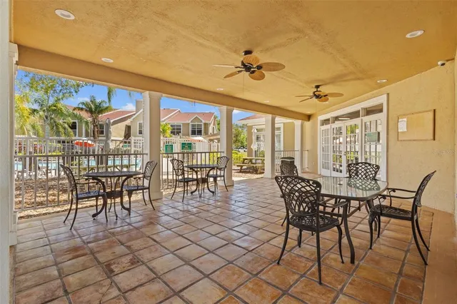 a view of a dining room with furniture a chandelier and wooden floor