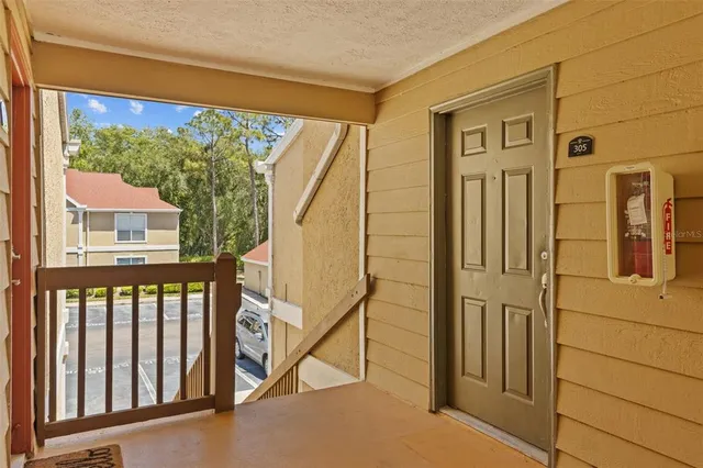 a view of a porch with wooden floor and stairs