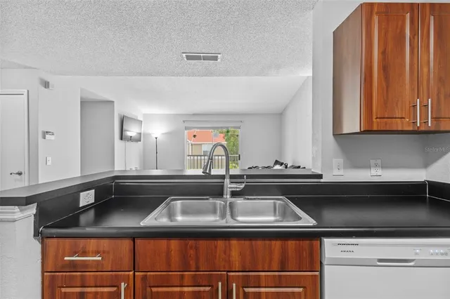 a kitchen that has a sink and cabinets
