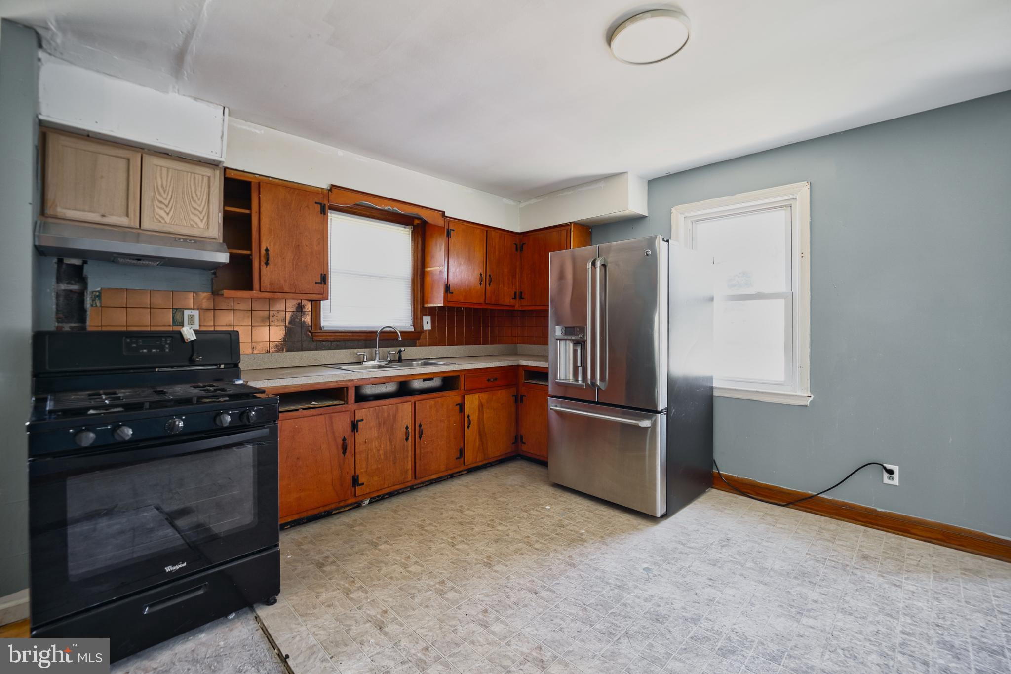 100 9th Avenue Baltimore, MD 21225 - Photo 12 of 38 a kitchen with a refrigerator stove and sink
