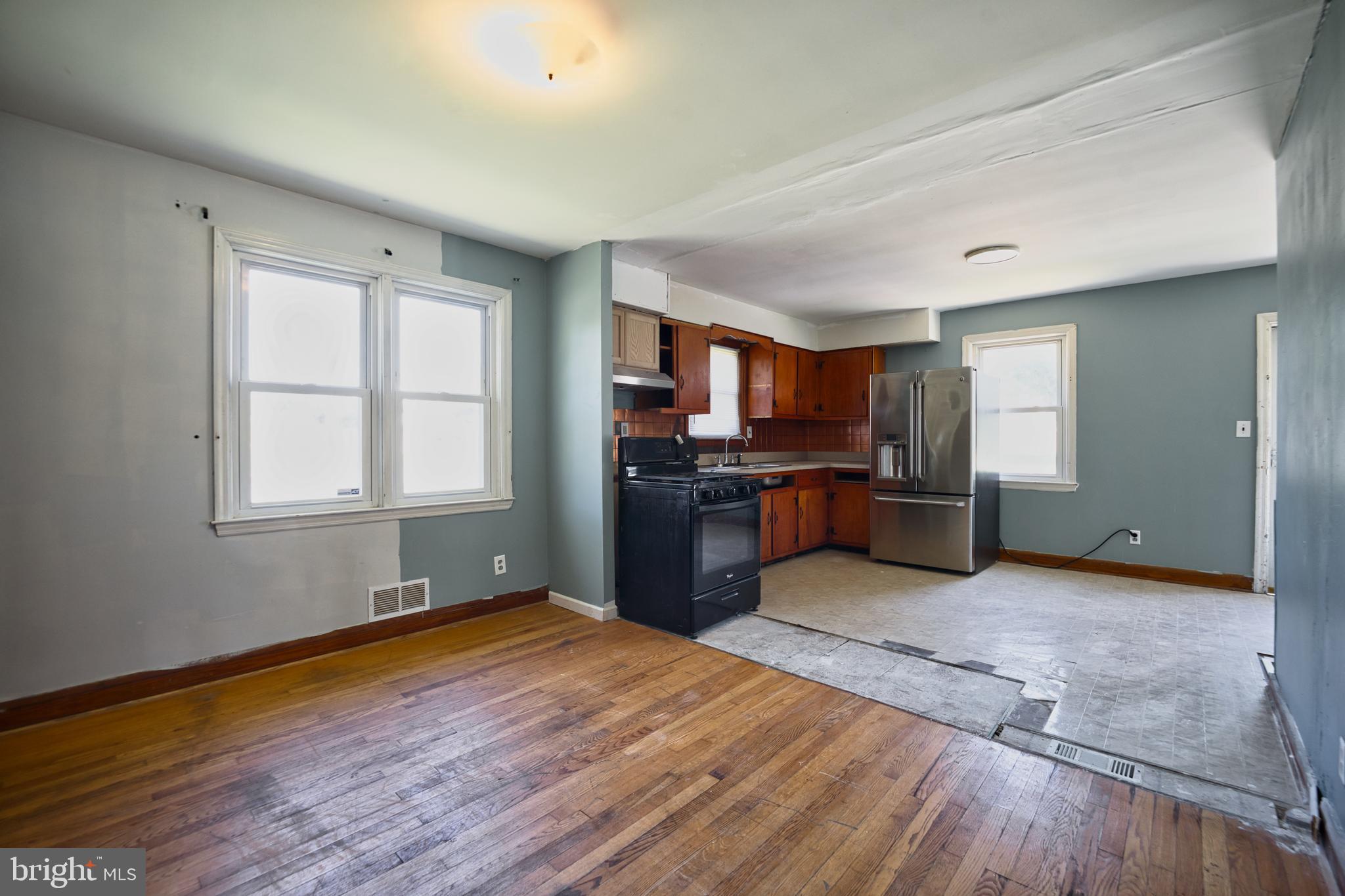 100 9th Avenue Baltimore, MD 21225 - Photo 13 of 38 a kitchen with stainless steel appliances granite countertop a refrigerator and a stove top oven