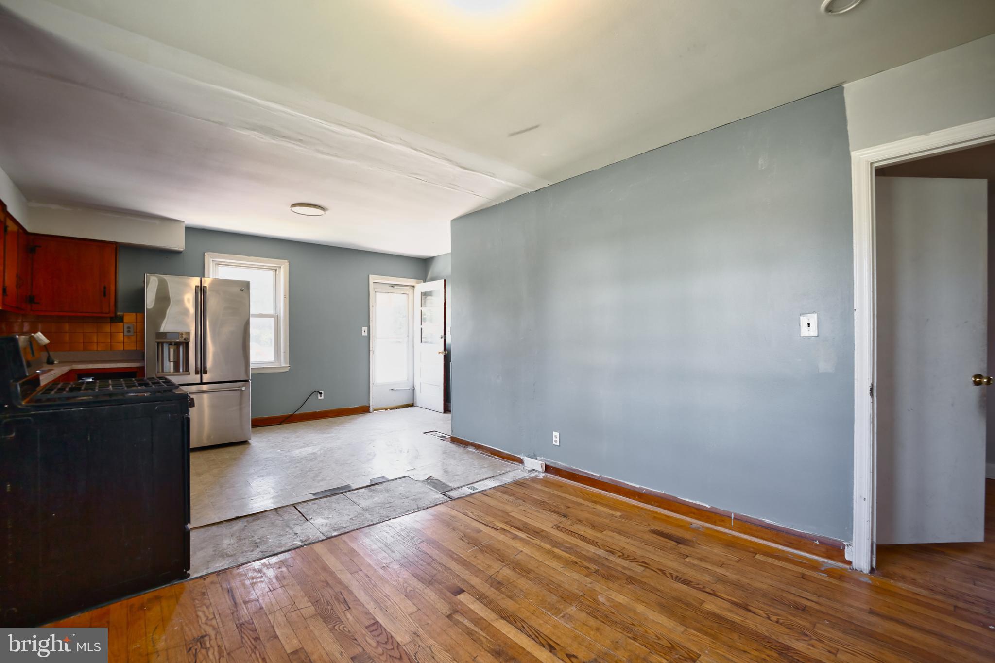 100 9th Avenue Baltimore, MD 21225 - Photo 17 of 38 a view of a kitchen with wooden floor refrigerator and windows