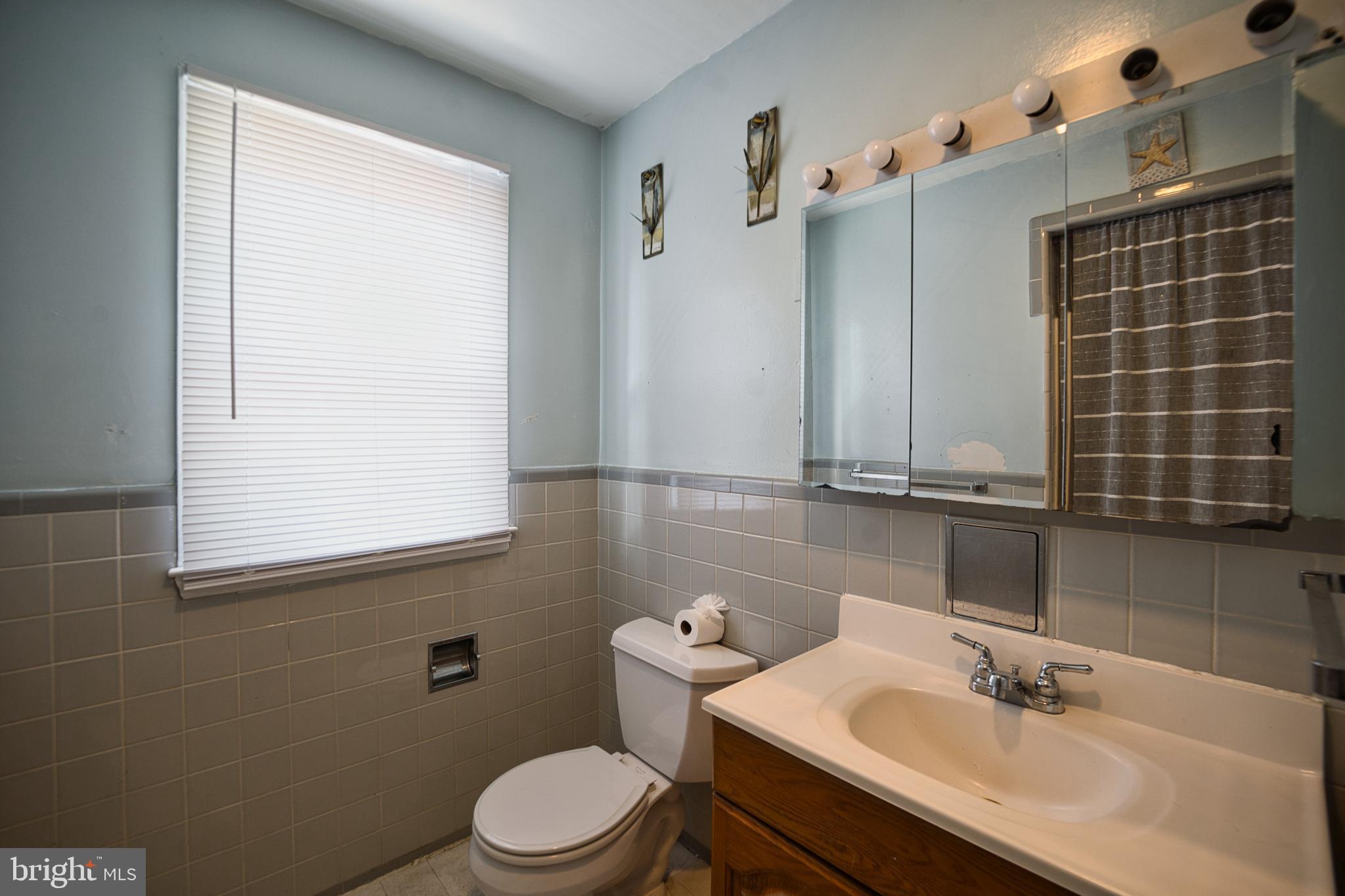 100 9th Avenue Baltimore, MD 21225 - Photo 21 of 38 a bathroom with a sink and a mirror