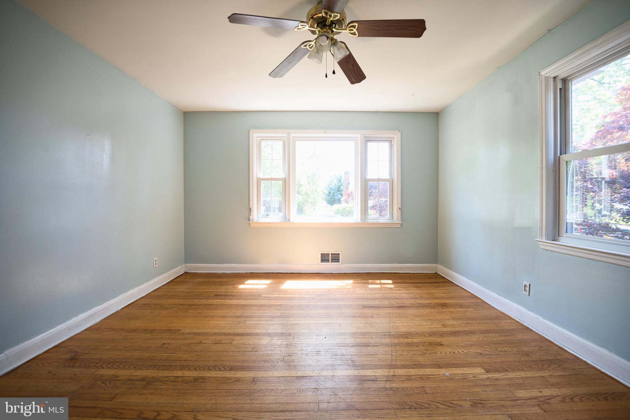 100 9th Avenue Baltimore, MD 21225 - Photo 24 of 38 an empty room with wooden floor chandelier and windows