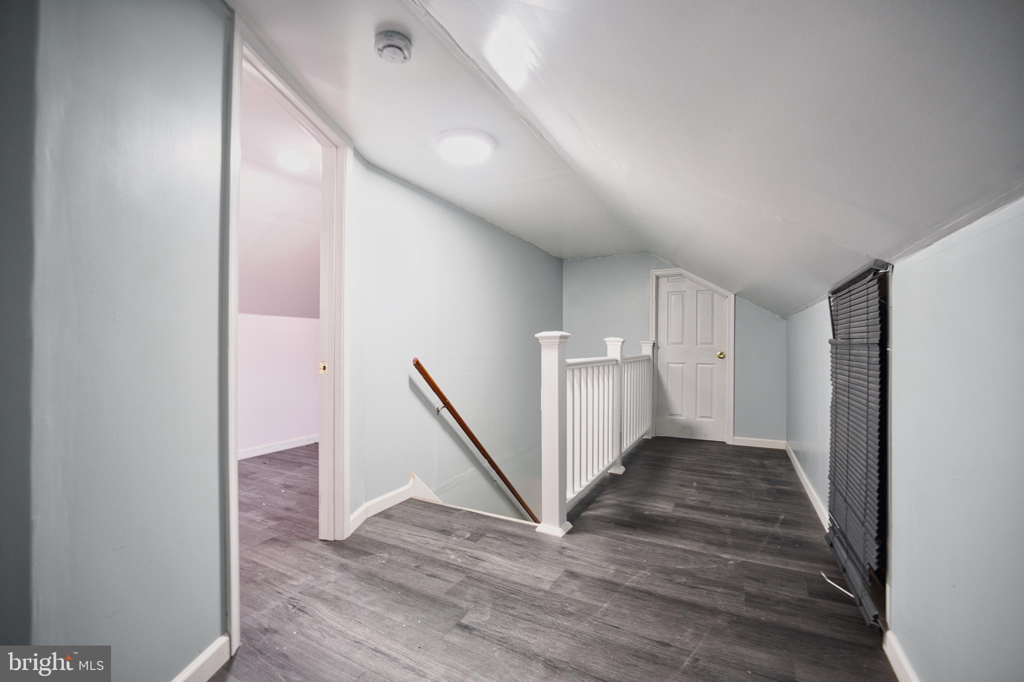100 9th Avenue Baltimore, MD 21225 - Photo 26 of 38 a view of a hallway with wooden floor